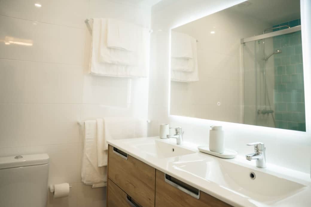Getting ready is easy with the spacious double vanity and large, backlit mirror.