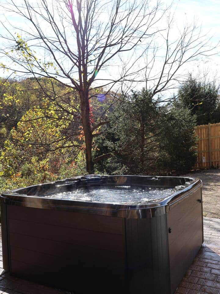 Private Aspen hot tub on a fully fenced patio—perfect for unwinding