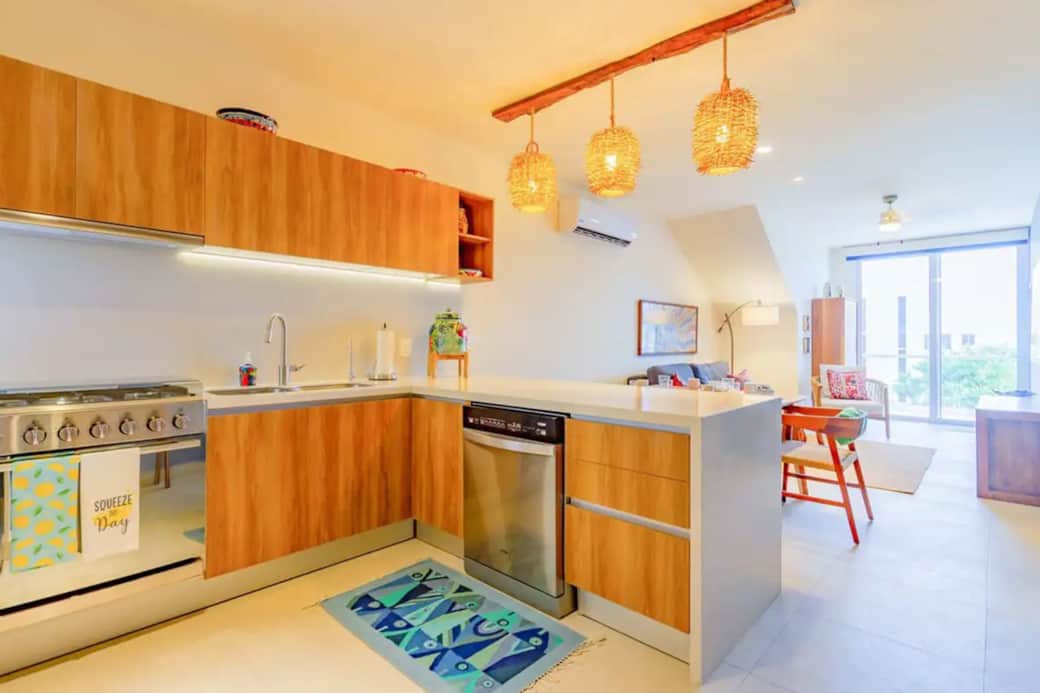 Kitchen perfection: Stocked with essentials—sleek dishwasher, quick microwave, versatile stove.