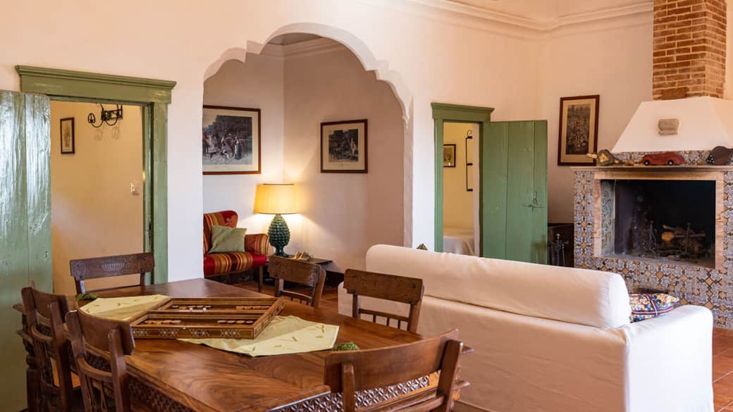Elegant lounge with fireplace and warm historic character.