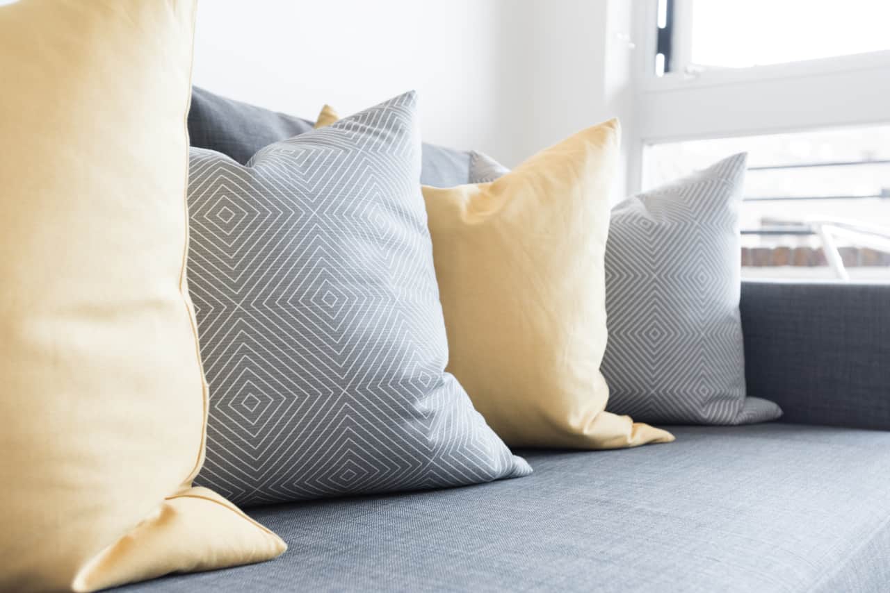Soft furnishings in mustard and grey tones