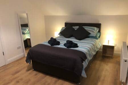 Bedroom 1 has two double beds, TV, and an en-suite with bath and shower Bedroom 1 has two double beds, TV, and an en-suite with bath and shower