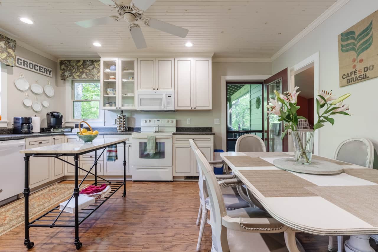 The kitchen table seats 6, and has a door to the covered Back Porch and a high table for 4.