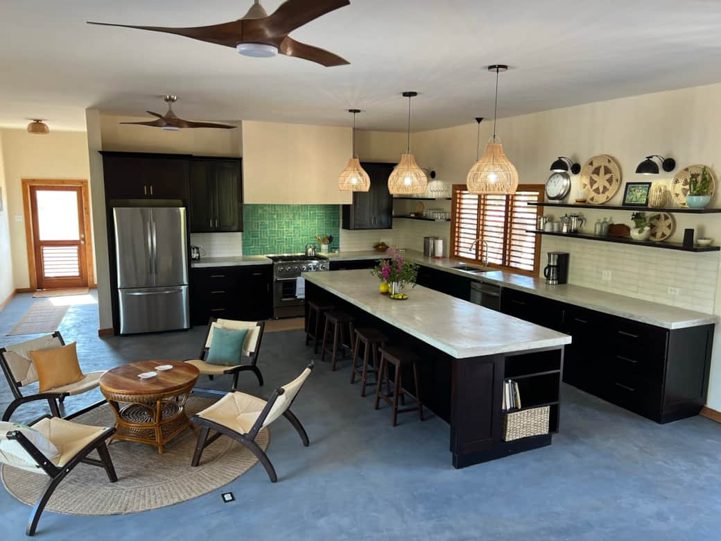 Airy and open, the large kitchen is the perfect spot to cook and gather  at the center of the home.