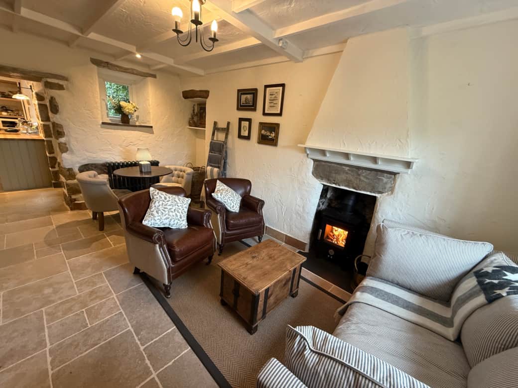 Cosy living room with log burner and comfortable sofas at Arwel Cottage, Llanbedrog
