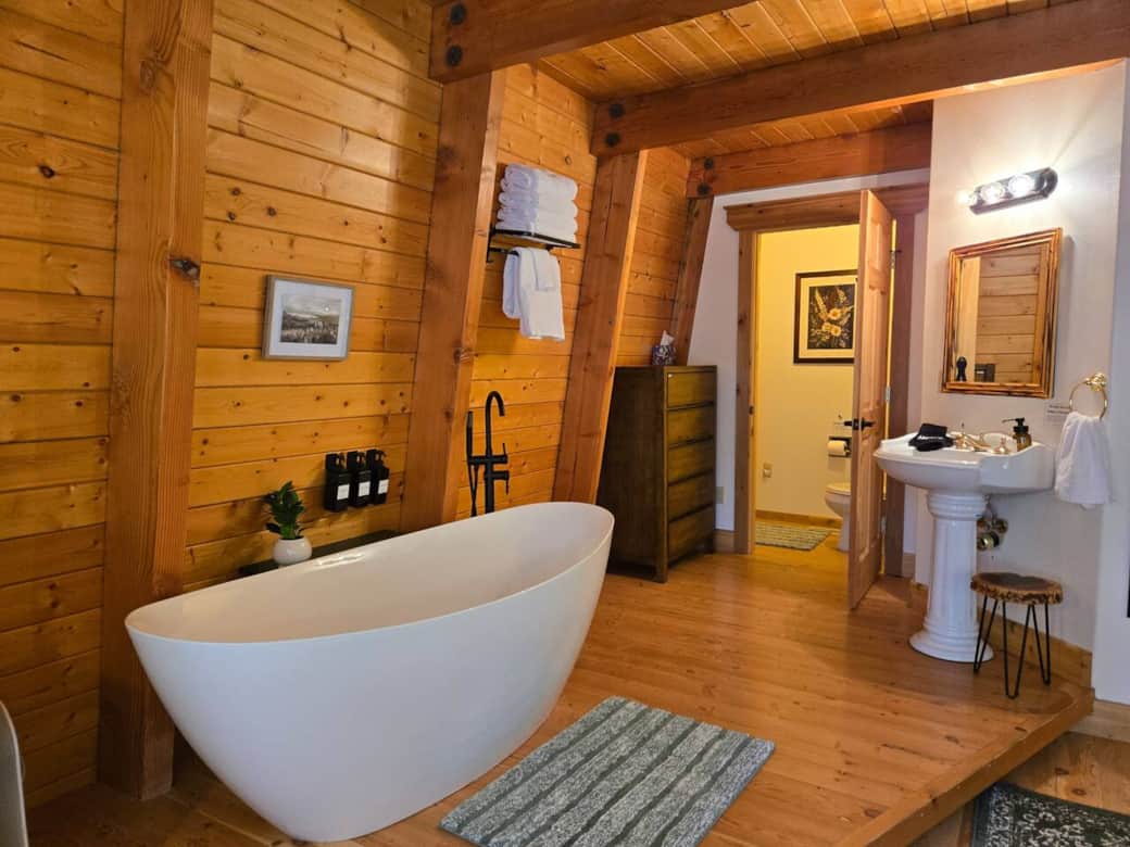 Start the day with a soak in the freestanding tub of the master bathroom. The bathroom also has a separate toilet area and a sink.