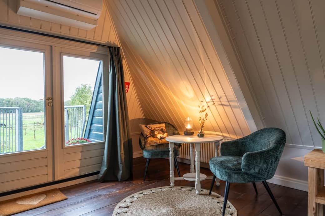 Lichte kamer met veel daglicht en uitzicht op het groene landschap.