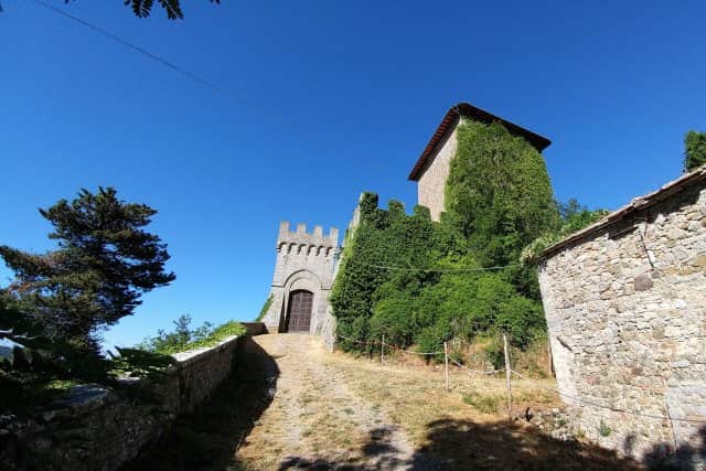 The entrance gate to Triana Castle, near Roccalbegna, Tuscany on a bright sunny day.