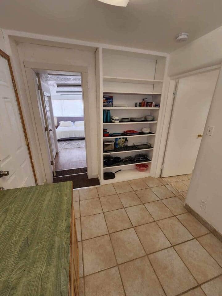 Pantry of the 2 bedroom house with cookware shown