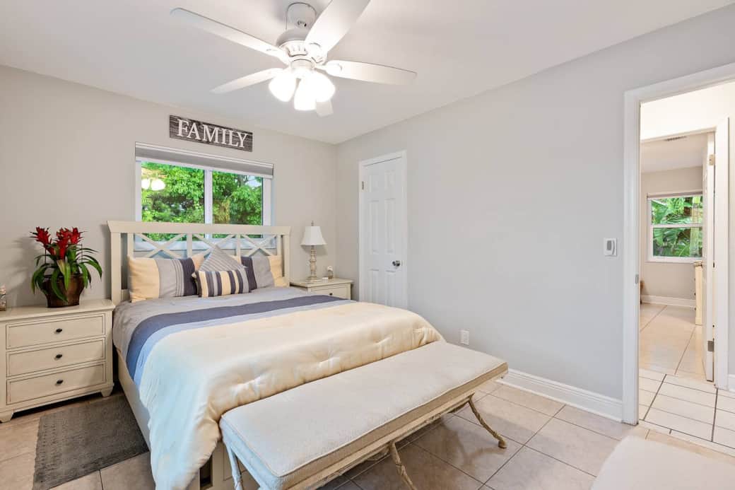 Guest bedroom with Queen size bed and views of the side and front yard. Blinds close to black out the room for late morning sleepers and a closet is available to store your luggage.