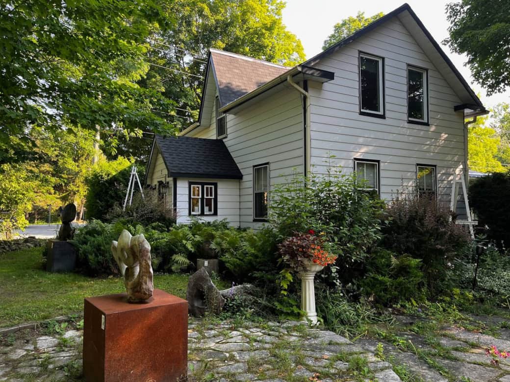 Sculptures, planters and gardens surround the house