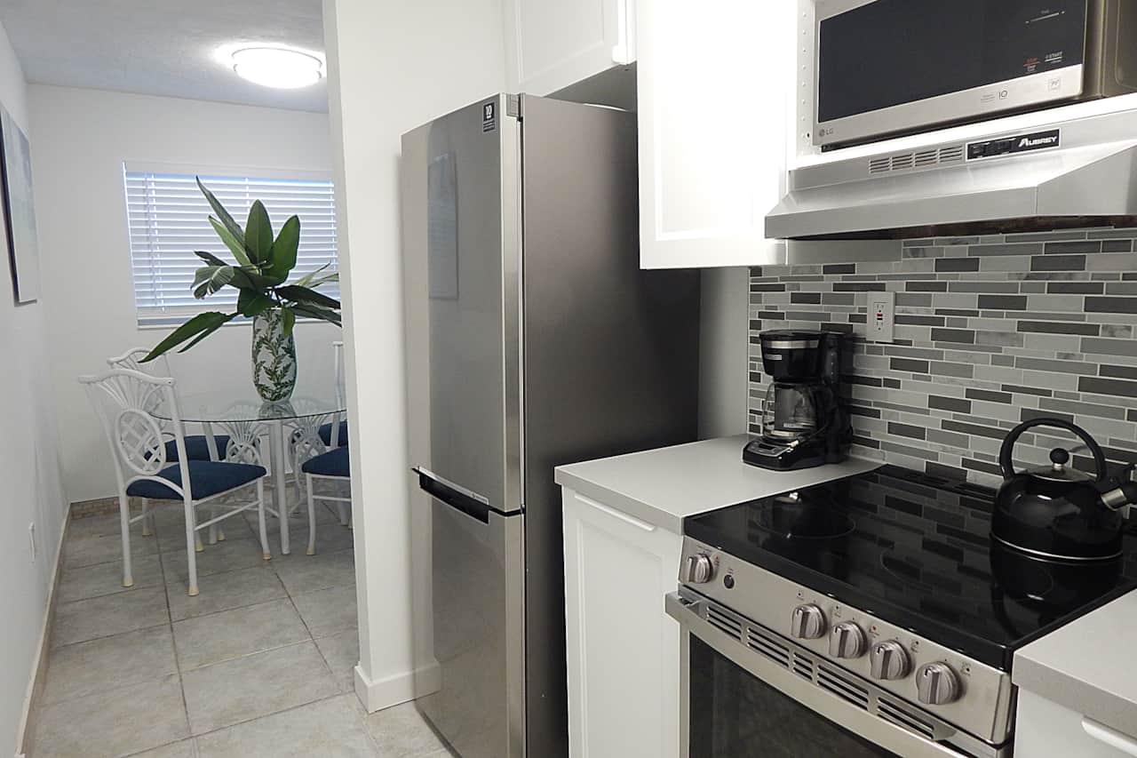 Unit #16 - Gorgeous new kitchen with new stainless steel appliances.