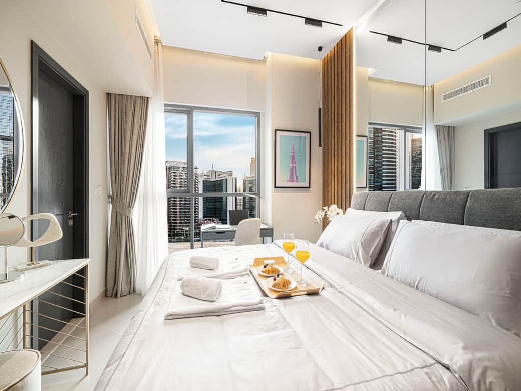 Quiet, refined bedroom with city views — designed for restful nights