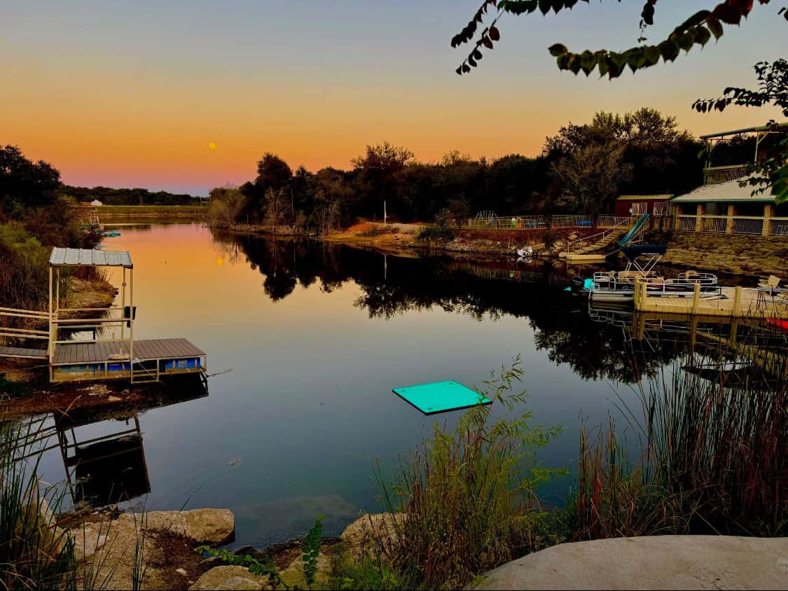 Sunset over the 35-bed Lake Godstone lodge with scenic views in Graford, Texas