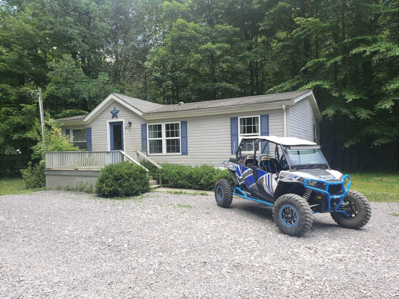 The Cottage with enough front parking for 3 car trailers more in the back past camping. 
