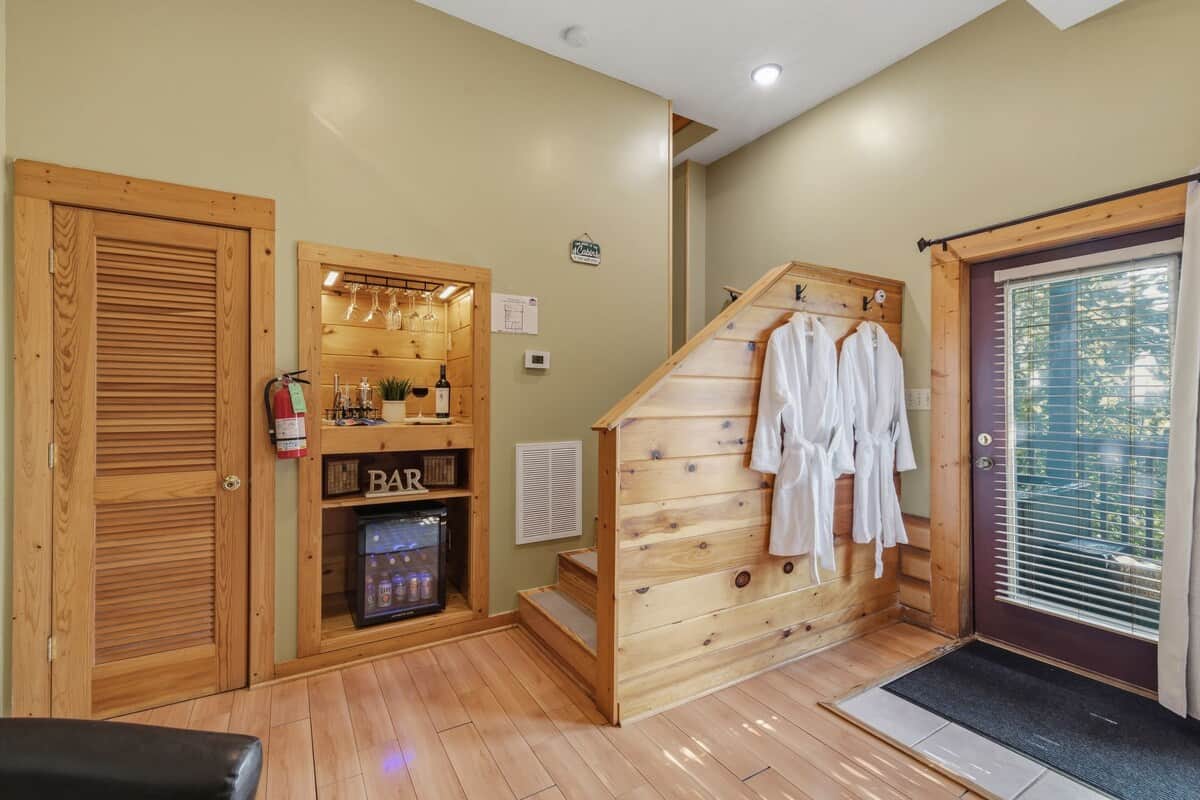 Soft bathrobes hang right beside the door to the private deck, ready for you to slip on before enjoying the hot tub under the mountain sky.