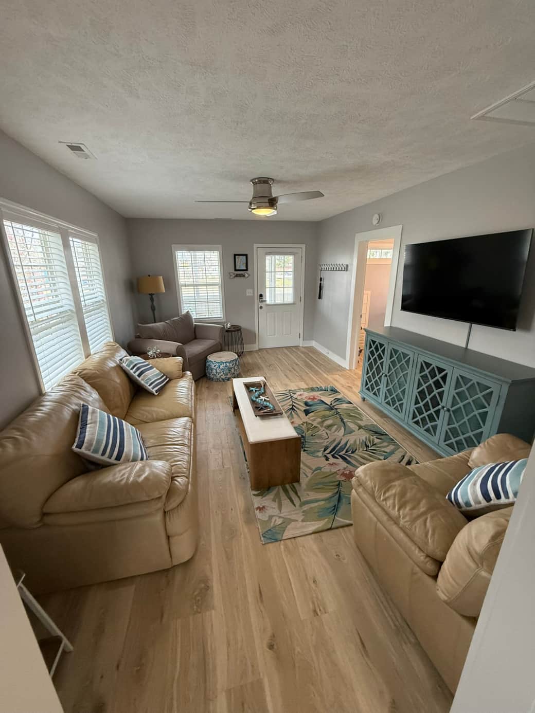Living room with comfy couch, TV and two oversized chairs. One pulls out into twin bed. Living room with comfy couch, TV and two oversized chairs. One pulls out into twin bed.