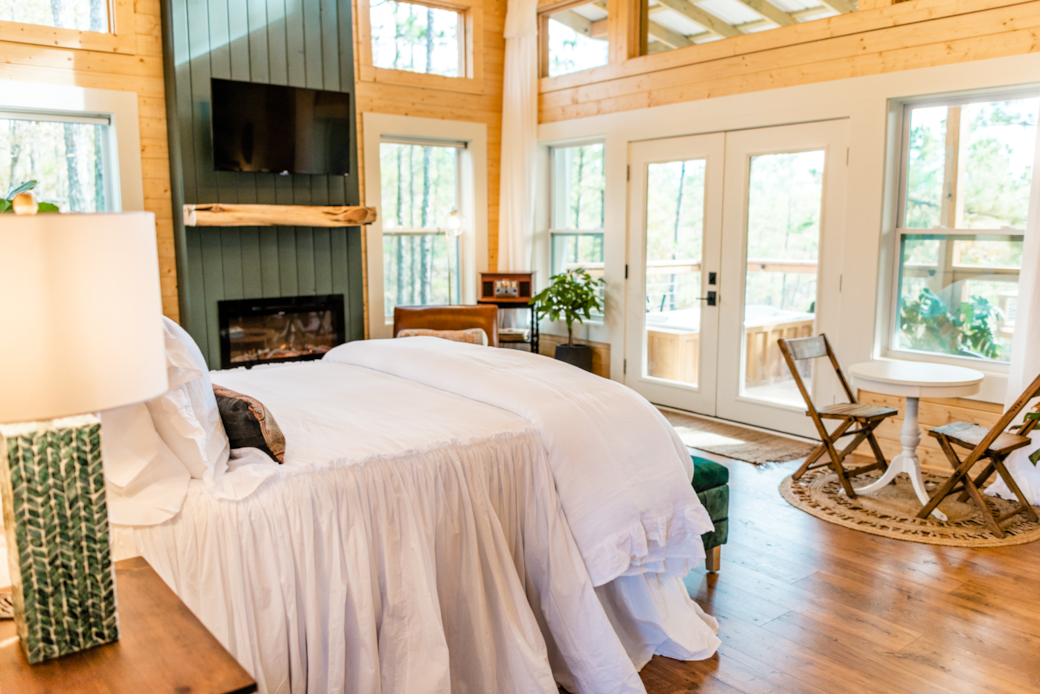 Main living space/bedroom flooded with views of the surrounding trees