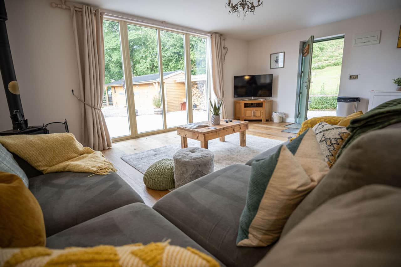 Graig Isaf's cosy lounge with garden views invites relaxation.