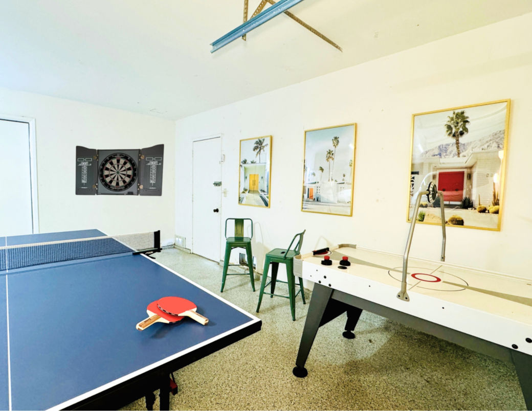 Game Room in Garage has ping pong table, small air hockey table, and darts. In addition has stools.