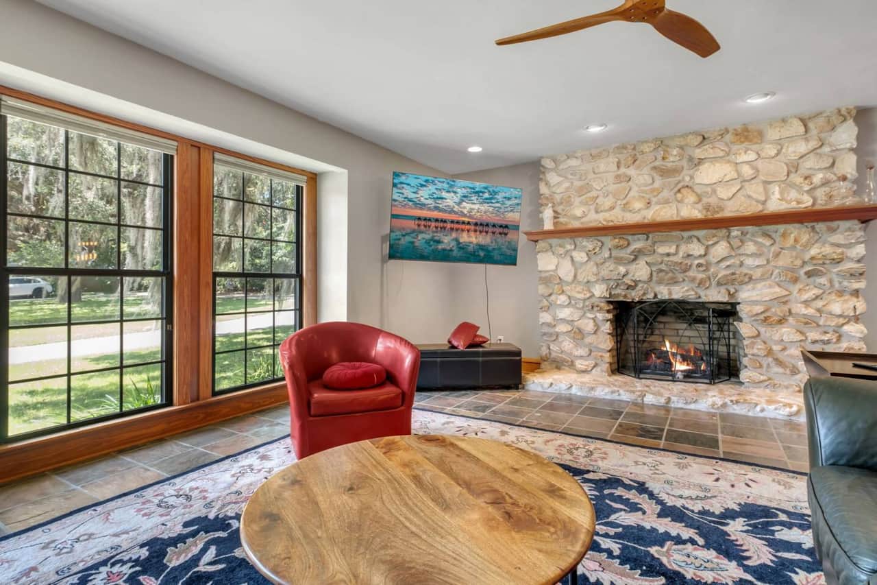 Living room with large TV, fireplace and reading nook (not pictured).