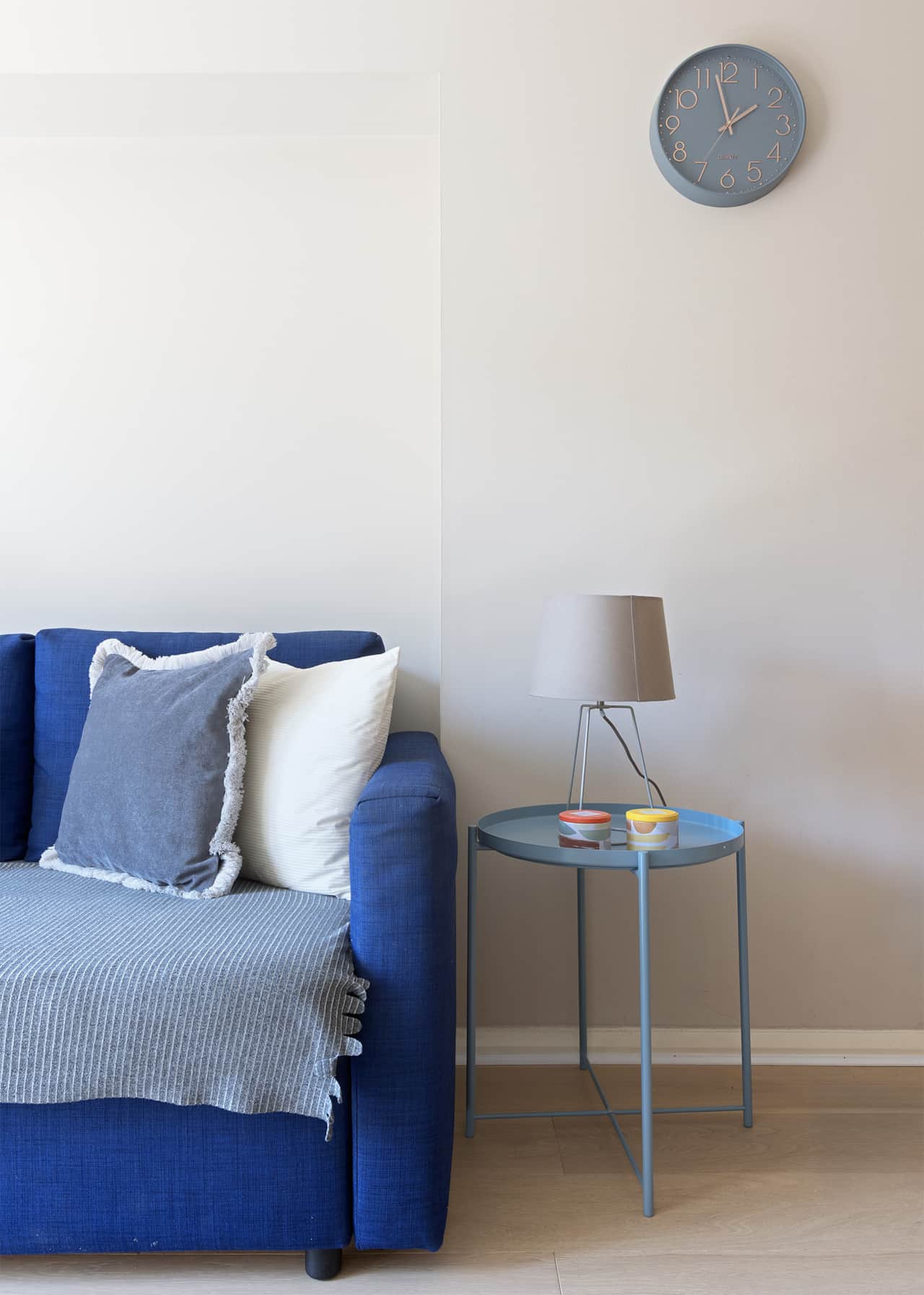 Side table detail with wall clock and reading lamp