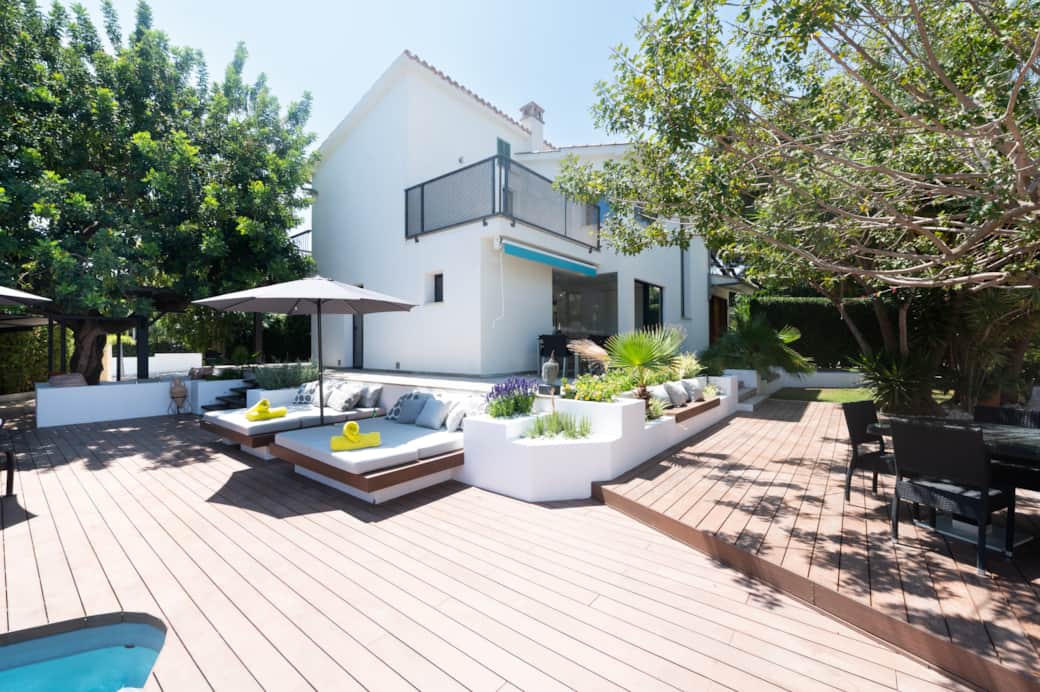 Poolside view with outdoor lounge area at Casa Guindilla in Portals Nous, Mallorca
