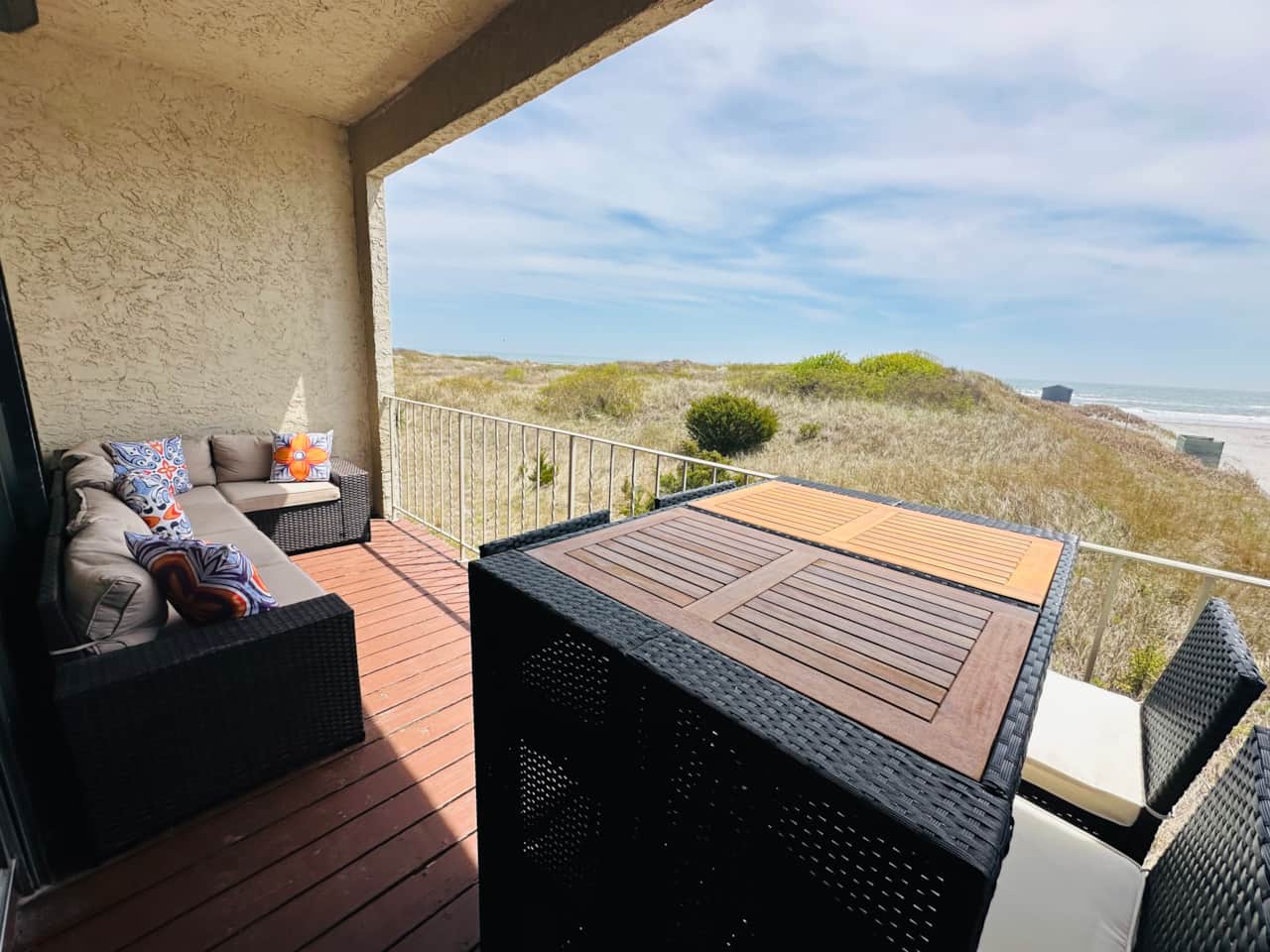 Oceanfront deck off 2nd floor family room with sectional sofa and table that seats 4 off 