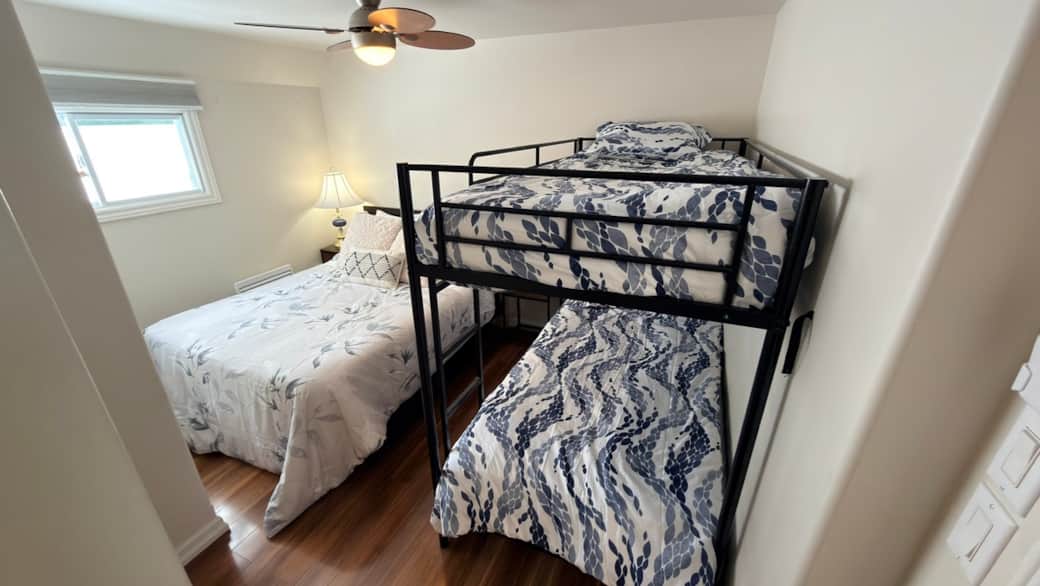 Family-friendly bedroom with a double bed and twin-over-twin bunk—perfect for kids or extra guests.