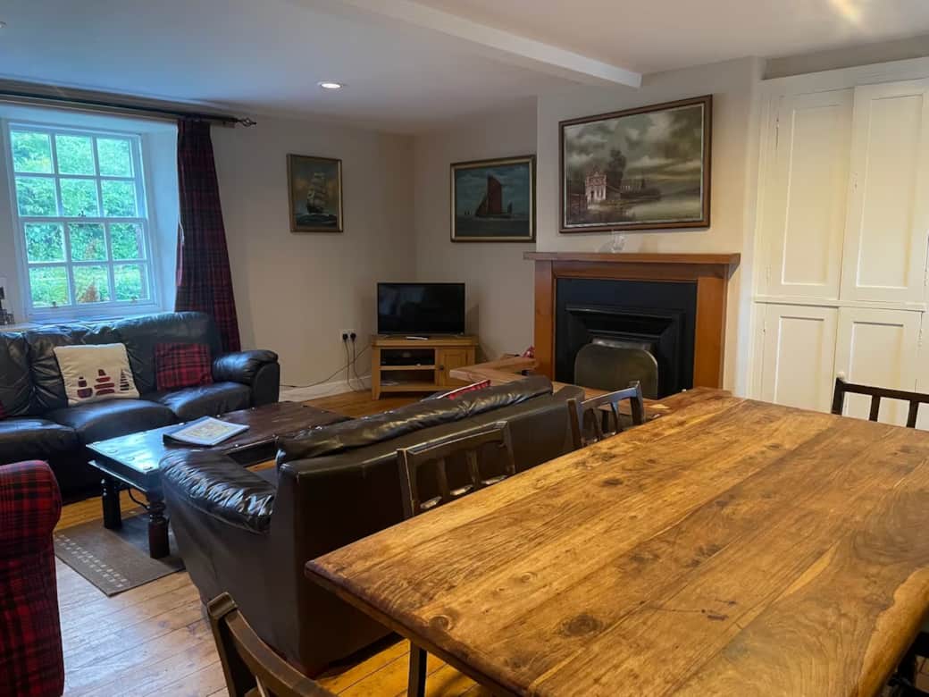 Sitting:dining room with open wood fire. Comfy seating for at least eight guests