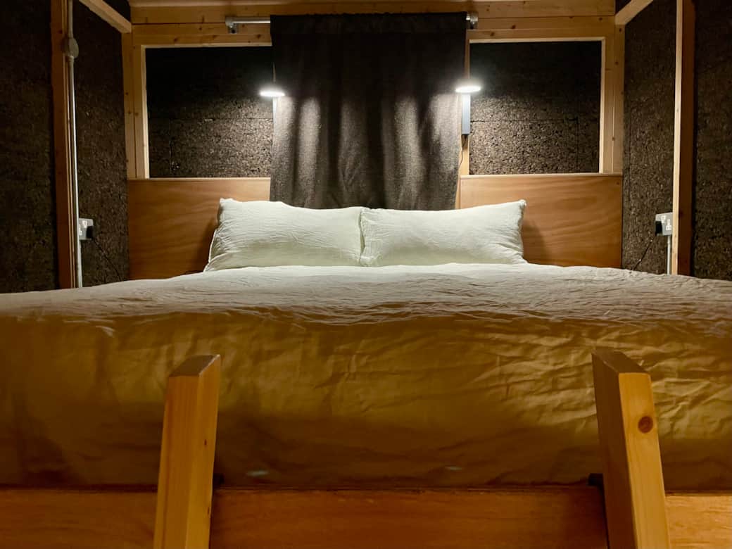 Restful nights await in the cabin’s inviting mezzanine bedroom (reached by a ladder) 