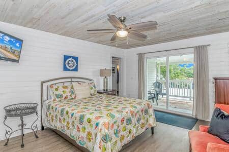 ☀️ Relax in this spacious coastal bedroom with comfy seating & private balcony access