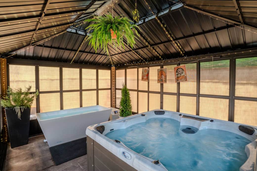 Hot tub and cold plunge in covered solarium 
