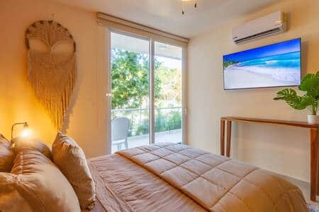 Master bedroom sanctuary: queen bed, 55" smart TV, private balcony. Your ultimate retreat awaits!