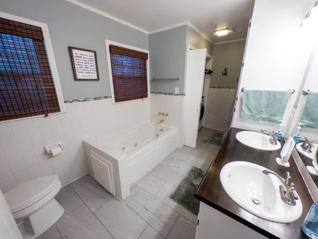 Spacious upstairs full bath with soaking tub, standing shower and double sinks. The full size washer and dryer are also found here. Spacious upstairs full bath with soaking tub, standing shower and double sinks. The full size washer and dryer are also found here.