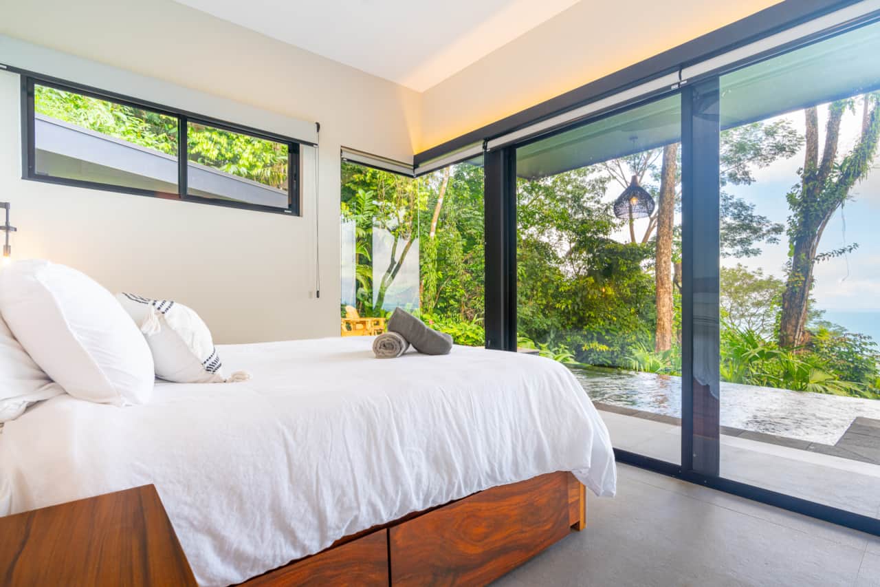 Bedroom opening onto the infinity pool and ocean view