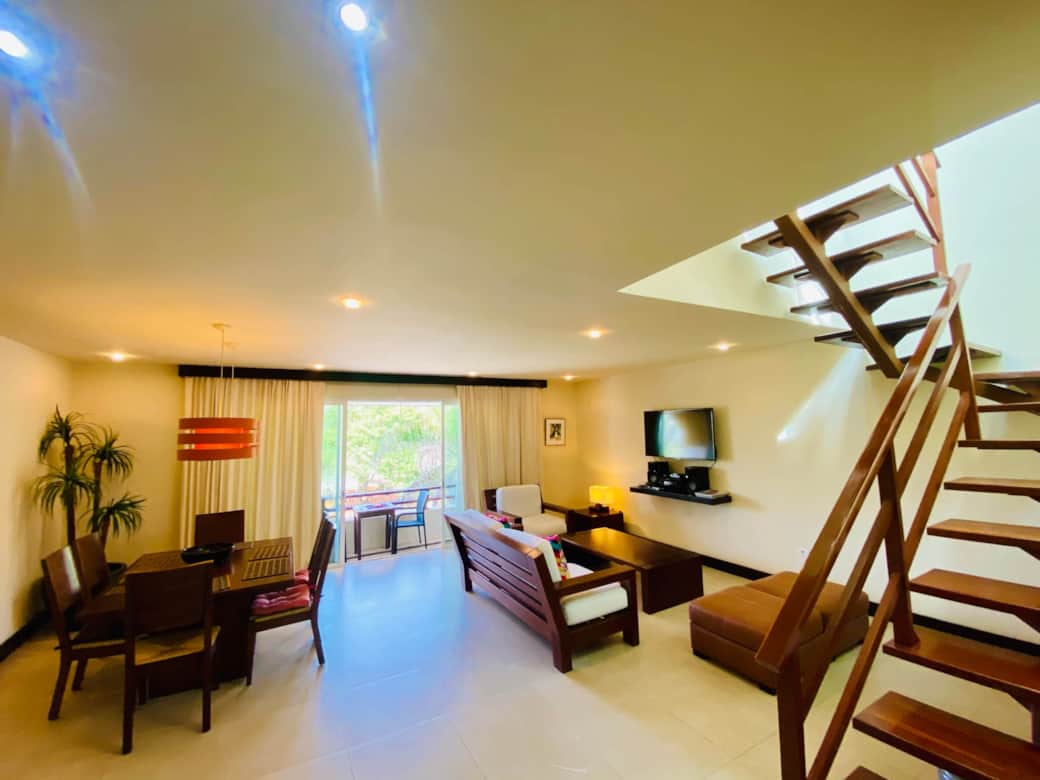 Dining and living room with staircase to upper level patio/pool. Dining and living room with staircase to upper level patio/pool.