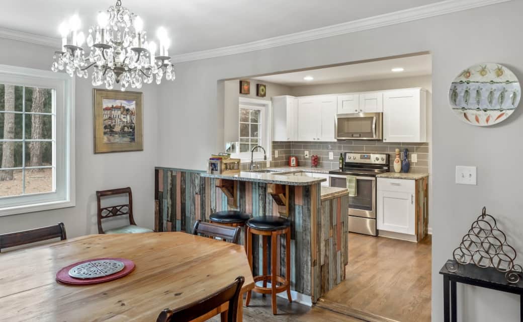 Dining room is large and roomy and open to the kitchen. It has a custom octagonal table made from vintage heart of pine. The legs are Victorian porch posts. The crystal chandelier is 1930s and German. Dining room is large and roomy and open to the kitchen. It has a custom octagonal table made from vintage heart of pine. The legs are Victorian porch posts. The crystal chandelier is 1930s and German.