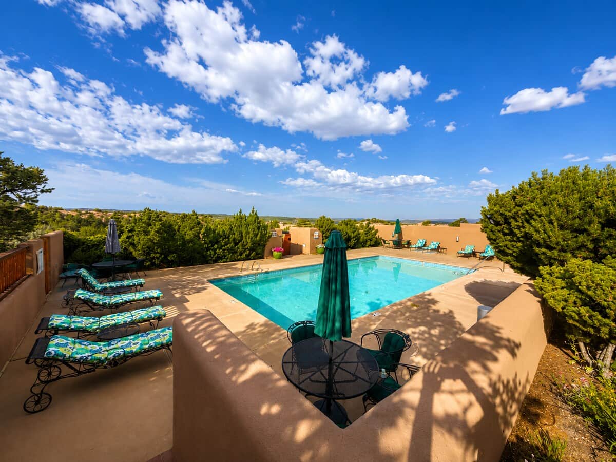 Resort-style pool with sweeping views across the Tesuque valley.