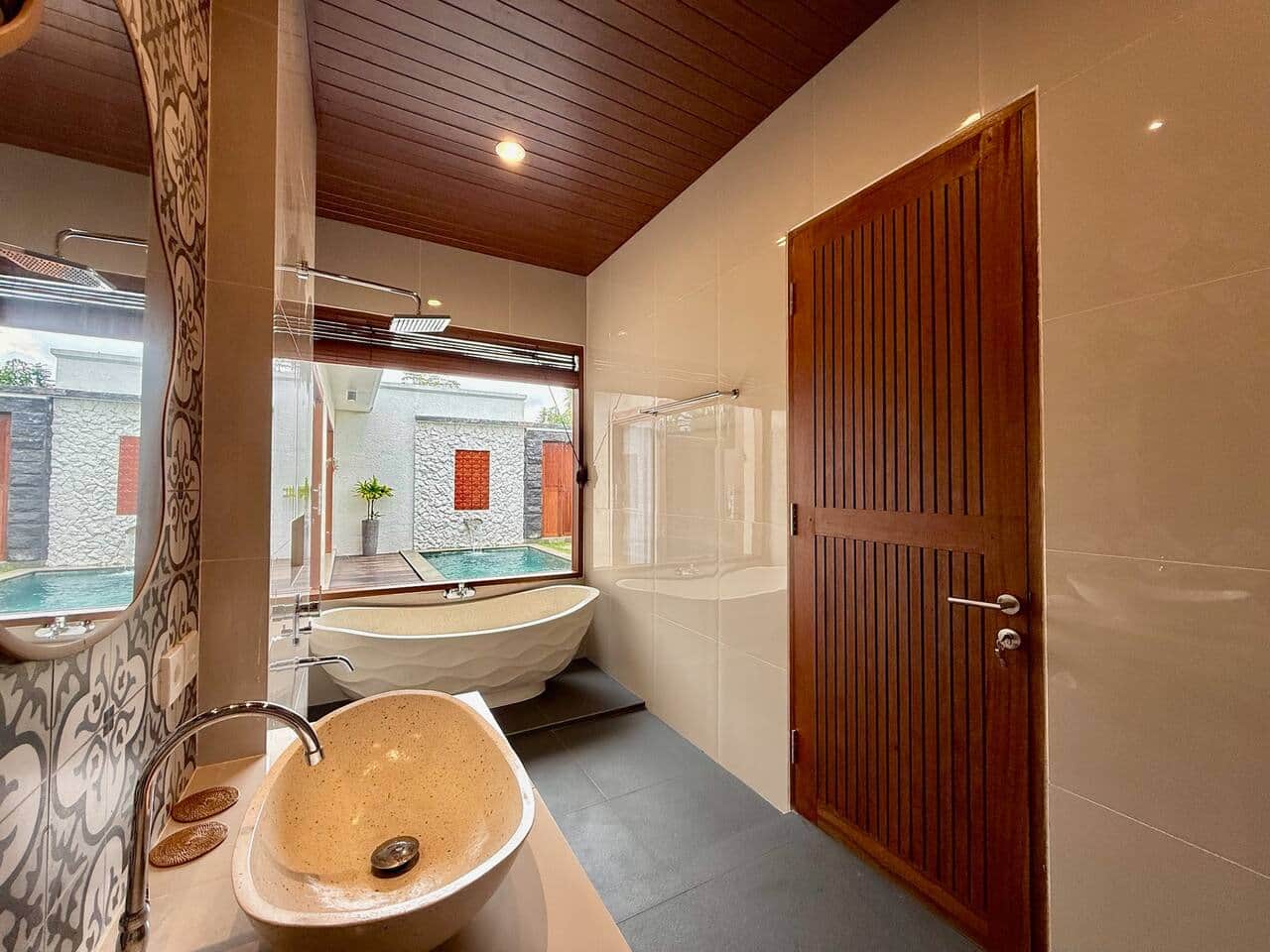 Spacious bathroom with bathtub in modern Bali villa