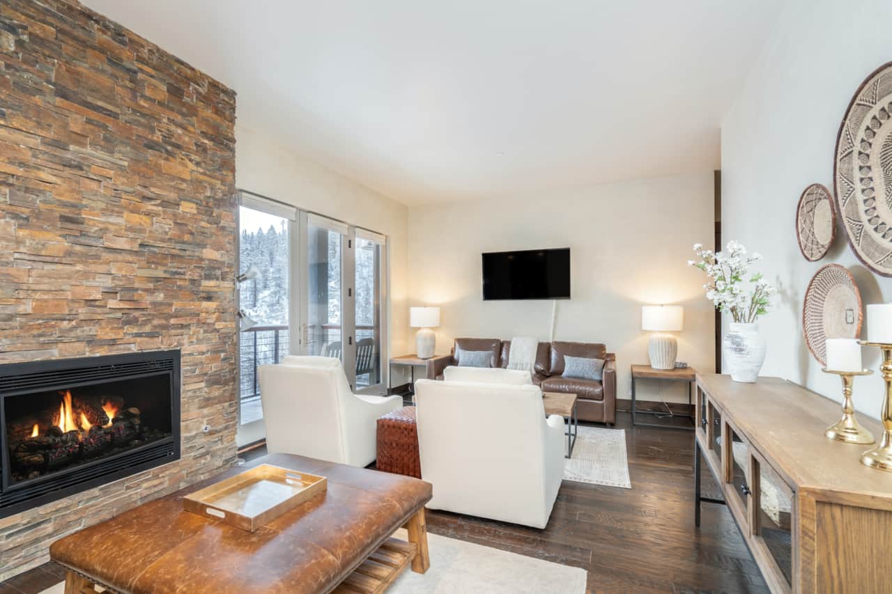 Spacious and contemporary seating area with sleeper sofa and gas fireplace