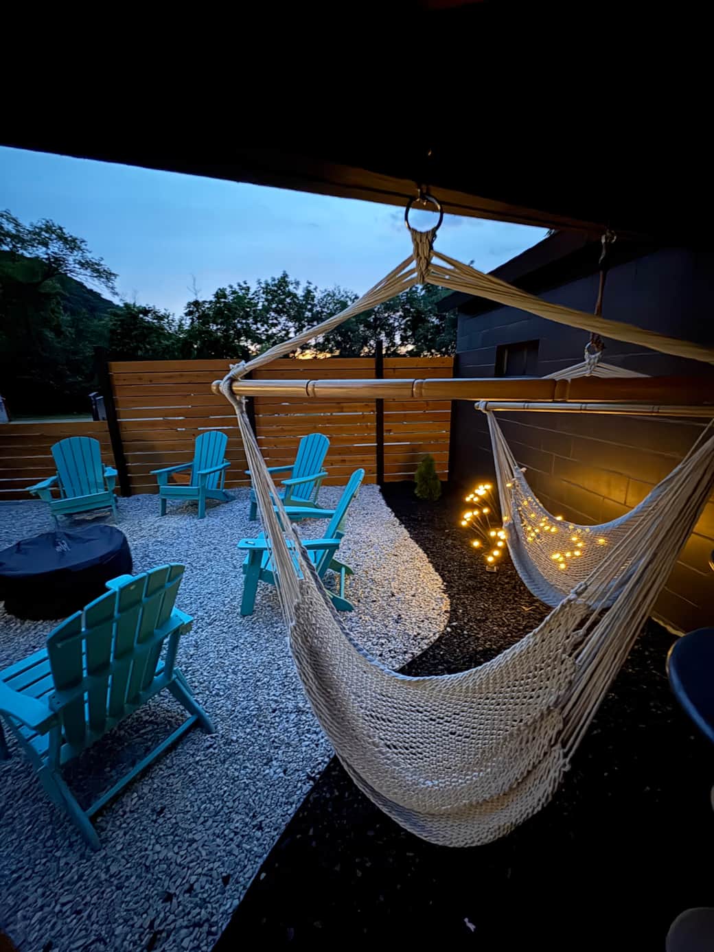 Private fenced in Outdoor gas fire pit, hammock swings and gas grill with patio dining.