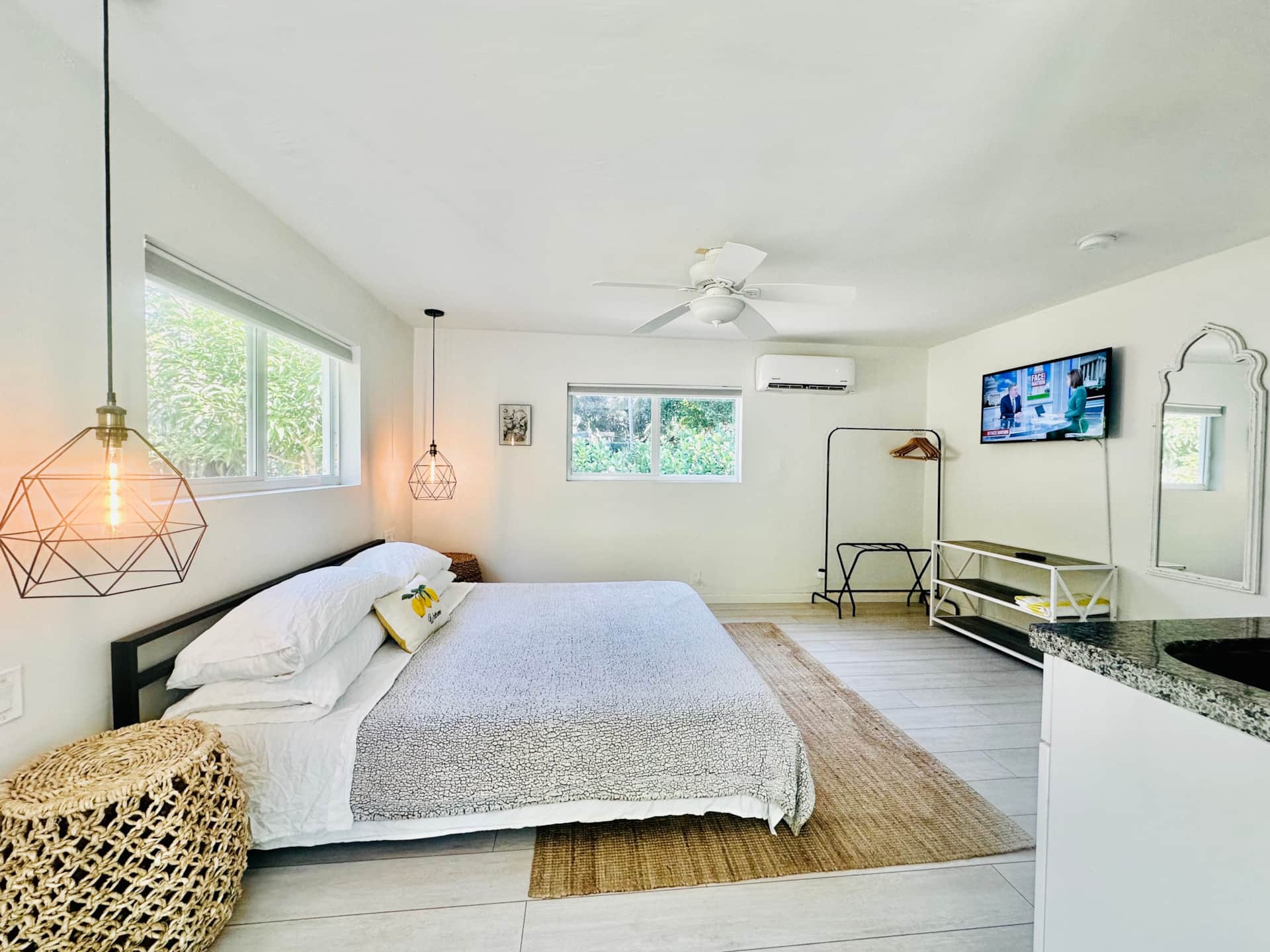 Casa Citron Unit 1 after renovation featuring new floors, split air conditioning, modern lighting, and hurricane impact windows and doors