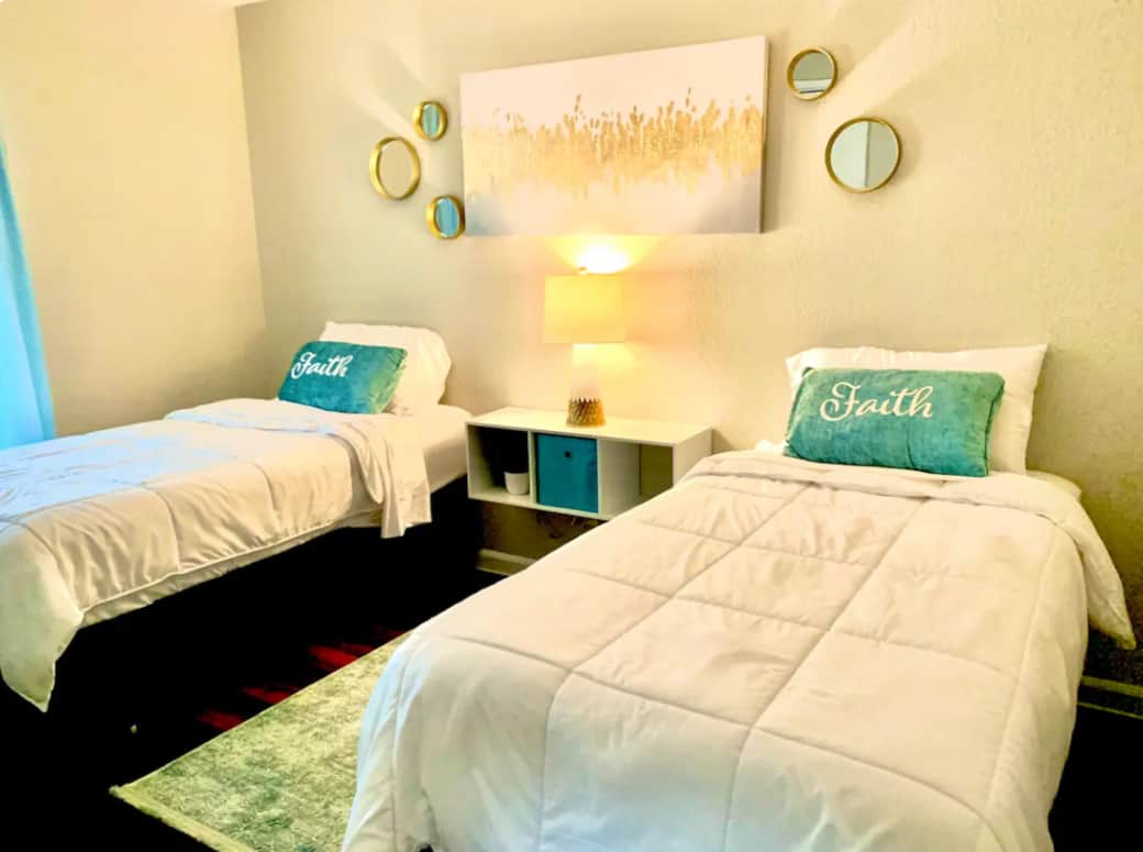 two twin beds with night light in between the beds