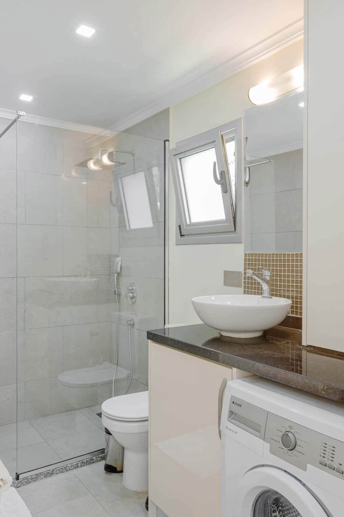 Annexe - shower room with washing machine.