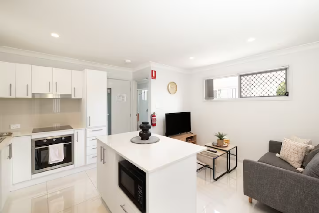 Living Area: Bright living space with comfortable seating and TV 