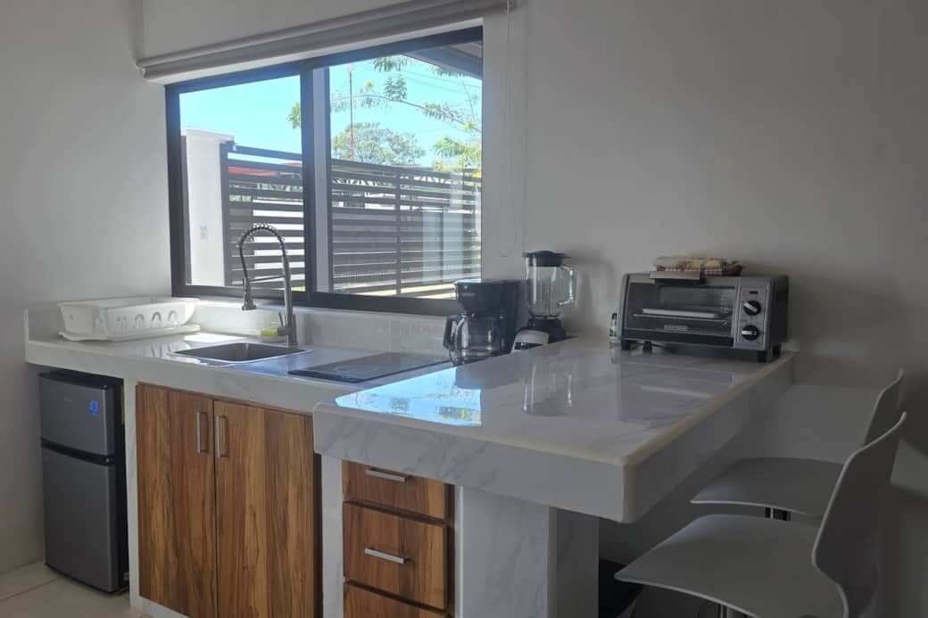 Full kitchen with mini refrigerator, blender, coffee maker, toaster oven