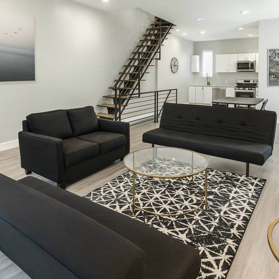 
Bright and spacious living room with three sofa beds, modern décor, and a flat-screen TV, flowing into the dining area.