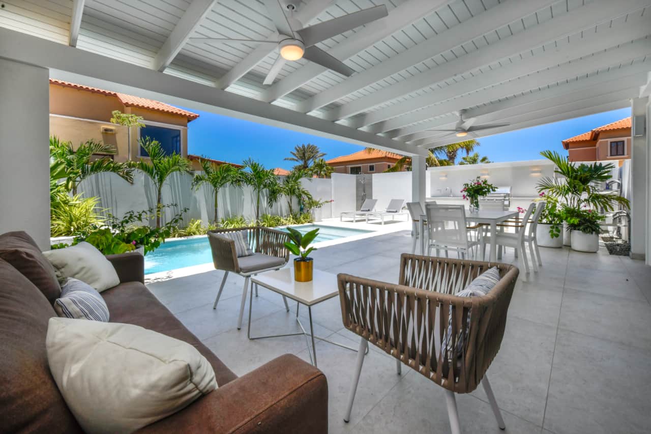 Fully enclosed backyard with private pool, lounging and dining areas, and BBQ