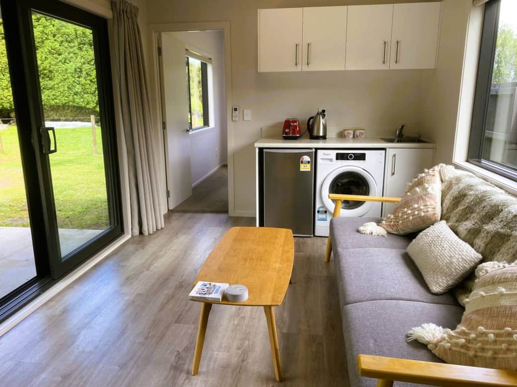 living area with mini fridge, washing machine, sink, toaster/kettle/tea/coffee ... plus of course country views.. this photo is looking through to the queen bedroom. We have supplied extras so you dont have to go to the kitchen pod for a cuppa!